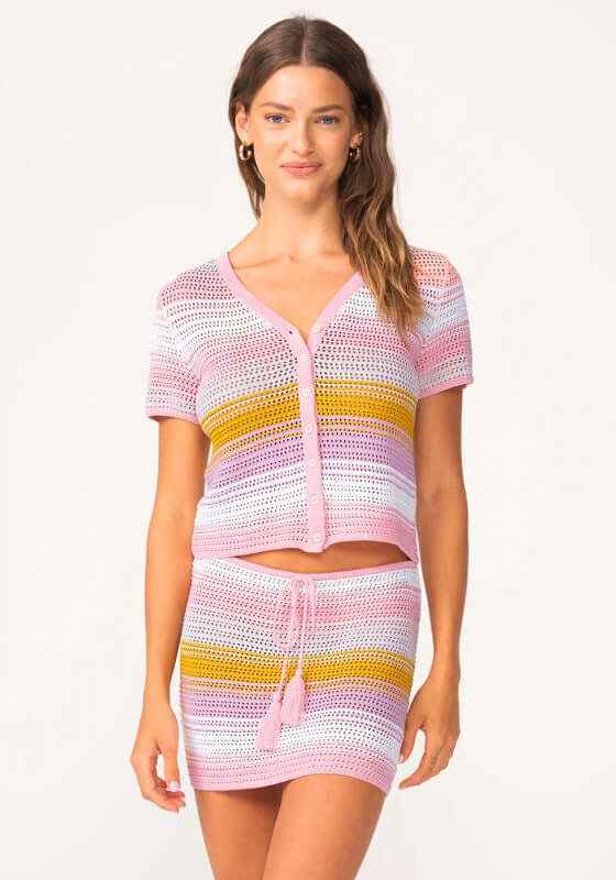 Clementine Ellie Crochet Shirt, a stylish crochet shirt in pastel colors, paired with a matching skirt for summer looks. Clementine Ellie Crochet Shirt, a stylish crochet shirt in pastel colors, paired with a matching skirt for summer looks. Back view of a woman wearing a colorful Clementine Ellie Crochet Shirt for a trendy look. Model wearing a stylish Clementine Ellie Crochet Shirt with crochet skirt, holding a bag, showcasing a summer outfit. PQ Swim Clementine Ellie Crochet Shirt